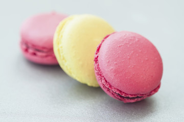Three colorful macaroons, french sweet delicacy