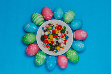 Fototapeta na wymiar colored easter eggs on a saucer on a blue background