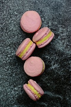 Pink macaroons on the dark background. Top view. Macarons isolated