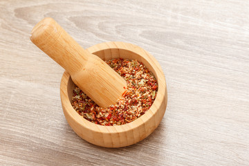 spices and mortar on wood background