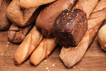 Fragrant bread on the table. Food concept on wooden cutting board