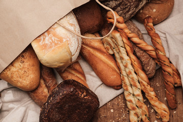 Fragrant bread on the table in a paper bag