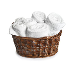 Wicker basket with clean terry towels on white background