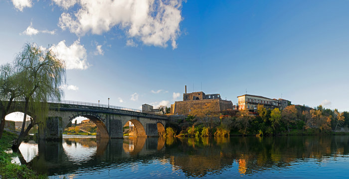 Panorama at night landscape of the city of Barcelos, district Braga, Portugal. Landscape on the river C&aacute;vado, Barcelos bridge, Pa&ccedil;o dos Condes, water mill and church. Buildings all in stone and old wi