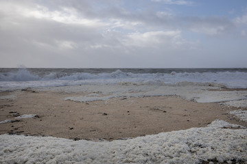 beach with sea foam before the storm Carmen hits the coast of La Faute Sur Mer, Vendee, France