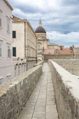 Fototapeta na wymiar walkway path on the old city wall of Dubrovnik, Croatia with view on the cityscape