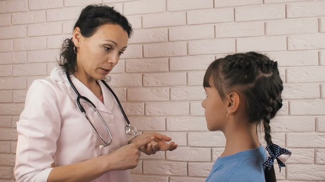 Doctor with child. The pediatrician is talking with the child.