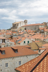 Obraz premium View over the orange rooftops of old town Dubrovnik from the ancient city wall with cloudy weather, Croatia
