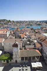 Fototapeta na wymiar Aerial view from the bell tower of Saint Lawrence Cathedral in Trogir ( with the city clock tower and loggias on Saint Lawrence square, Croatia