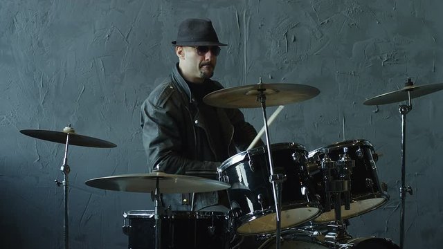 Professional and stylish rock drummer playing on drum set. Shot on RED HELIUM cinema camera in slow motion.