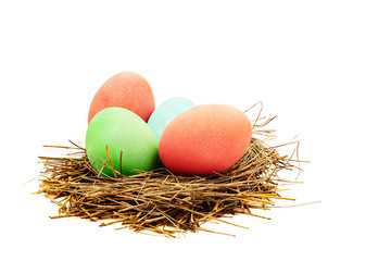 Coloured Easter eggs in the nest of straw