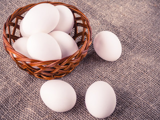 Fresh eggs in a wooden basket