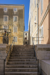 Fototapeta na wymiar Street in Old Town Zadar with a stairway and bike parked , Croatia