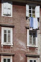 laundry drying on a line between windows in Zadar, Croatia