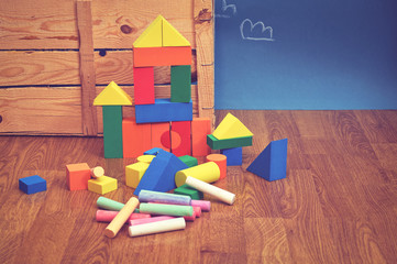 Colorful wood block toy on floor. Wooden building blocks