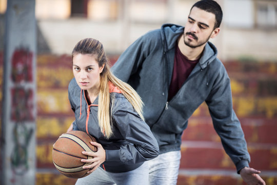 Young couple playing basketball