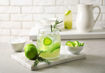 Jar with fresh lemonade and ingredients on table