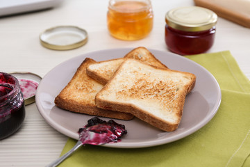 Toasted bread served with jam on table