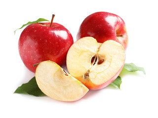 Ripe red apples with slices on white background