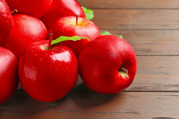 Ripe red apples on wooden background
