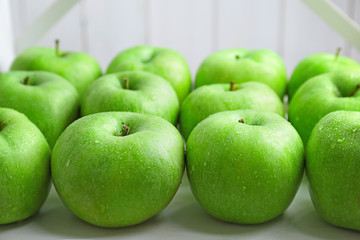 Fresh green apples on light table