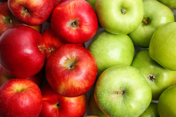 Fresh green and red apples as background