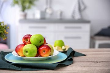 Ripe fresh apples on table