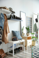 Stylish hallway interior with large mirror and shoe rack