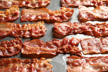 Fried bacon on metal surface, closeup