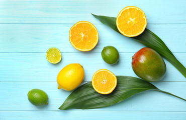 Set of fresh tropical fruits on color background