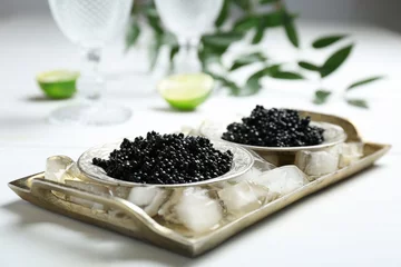 Zelfklevend Fotobehang Plates with black caviar served with ice cubes on table © New Africa