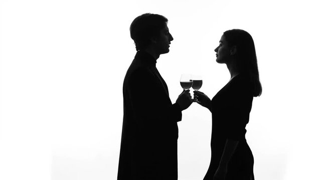 Silhouette of wealthy man getting acquainted with pretty lady at party, flirt