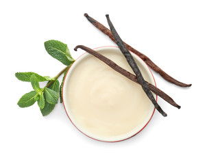Vanilla pudding, sticks and fresh mint on white background