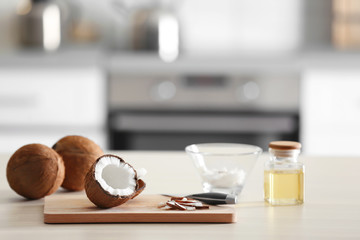 Jar with coconut oil and nut pieces on kitchen table © New Africa