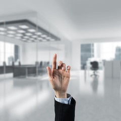 Choosing gesture of businessperson in elegant modern interior in