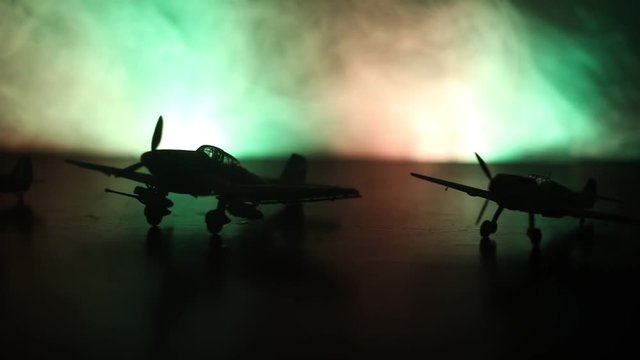 Slider shot. Retro World War 2 propelled model planes in possession.  Dark foggy light background. War scene. Useful for documentary.  Selective focus