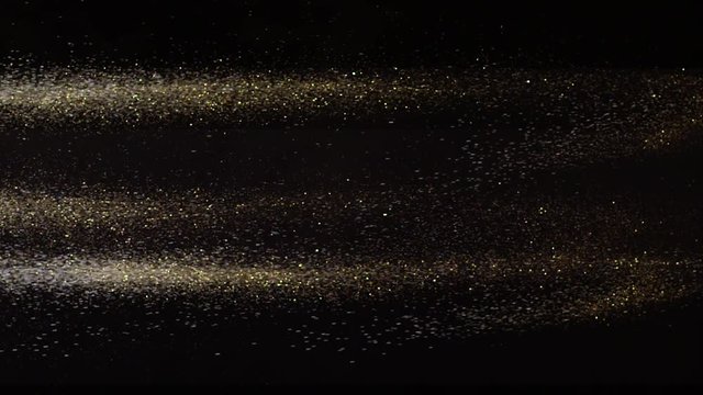 Falling real golden dust from right to left on black background. This footage can be used on first plan of different videos by blend modes Overlay or Screen. Shot on RED camera in slow motion.