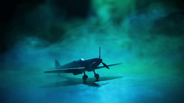 Slider shot. Retro World War 2 propelled model planes in possession.  Dark foggy light background. War scene. Useful for documentary.  Selective focus