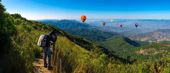 Panorama professional photographer take landscape photos on mountain