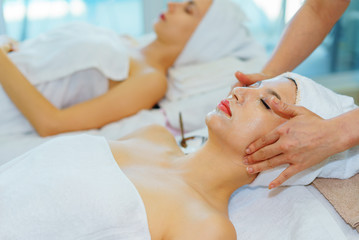 Obraz na płótnie Canvas face massage.Face Mask.beautiful woman relax in spa salon.spa wellness set.beauty and fashion set on the white table.