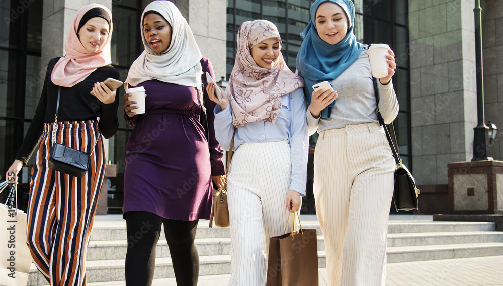 Wall mural islamic women friends shopping together on the weekend