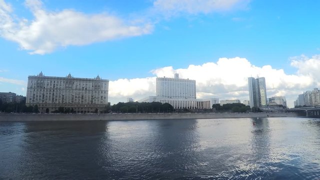 house of government and other buildings near a river timelapse