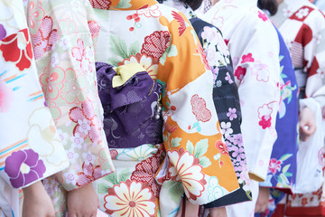 Young girl wearing Japanese kimono standing in front of Sensoji Temple in Tokyo, Japan. Kimono is a Japanese traditional garment. The word "kimono", which actually means a "thing to wear"