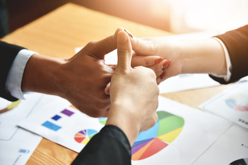 Business partners with thumbs up.