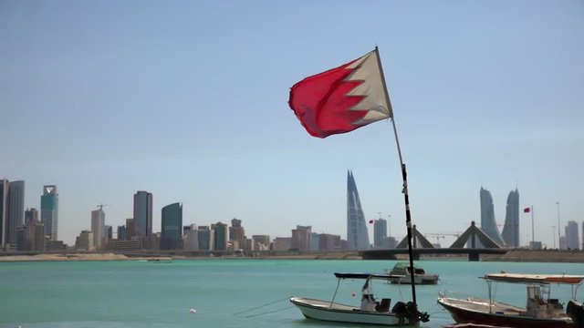 Bahrain. Fishermen Boats, Flag and Manama Skyline