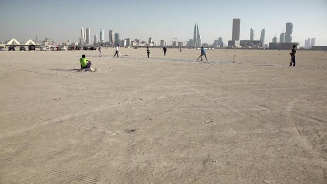 Cricket Players and Manama Skyline. Bahrain