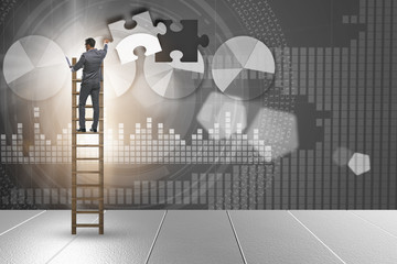 Businessman putting together jigsaw puzzle pieces