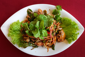 Thai food, A spicy Thai salad made with blood cockles on wood table.