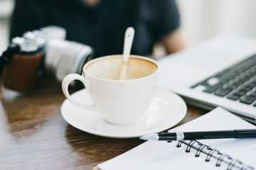 a cup of coffee latte has drank on wooden table