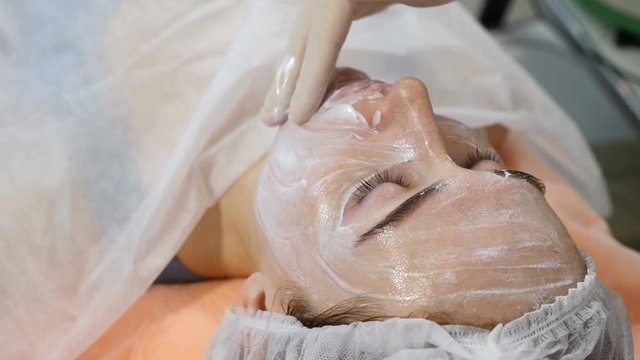 Beauty concept. Plastic surgeon concept. Beautician spreads facial mask before botox injection. Beauty injection procedure. Shot in 4k
